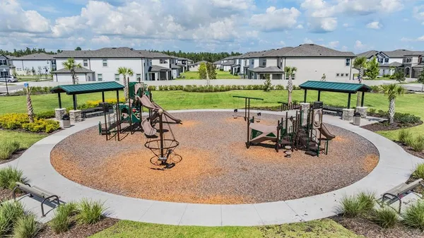 a view of a white house next to a yard
