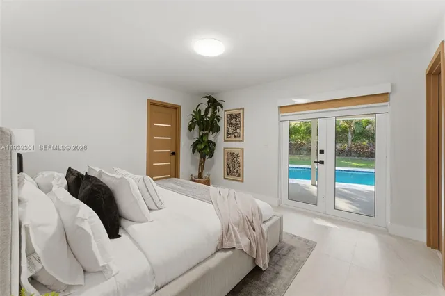 a bedroom with a large bed and a large window