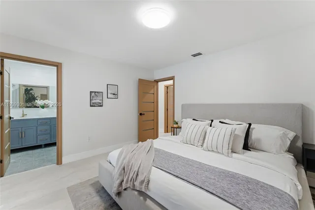 a bedroom with a bed and a view of bathroom