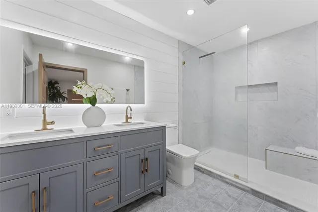 a bathroom with a toilet a sink a tub and mirror