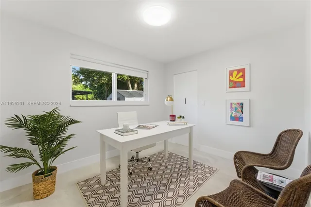 a view of a workspace with furniture and a potted plant
