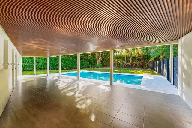 a view of a swimming pool with red umbrella
