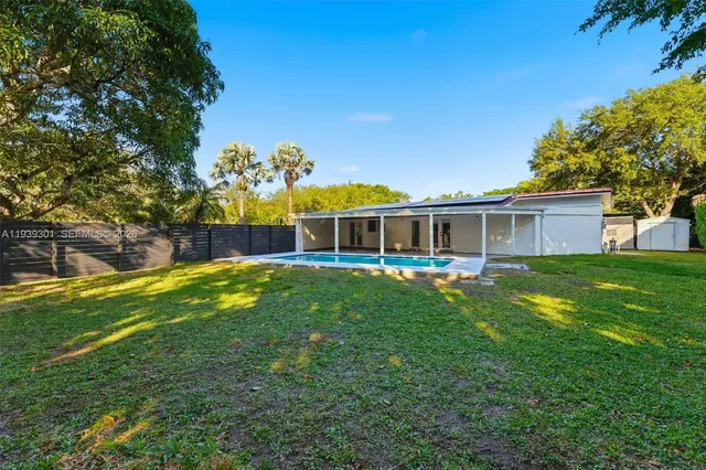 a view of a house with a backyard