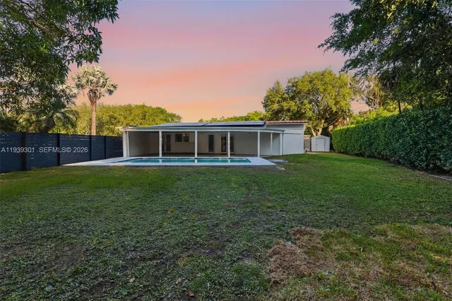 a view of a house with a backyard