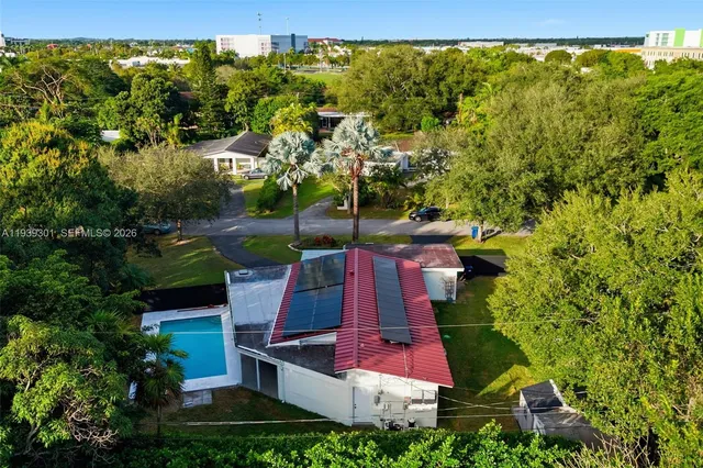 an aerial view of residential house with outdoor space and swimming pool