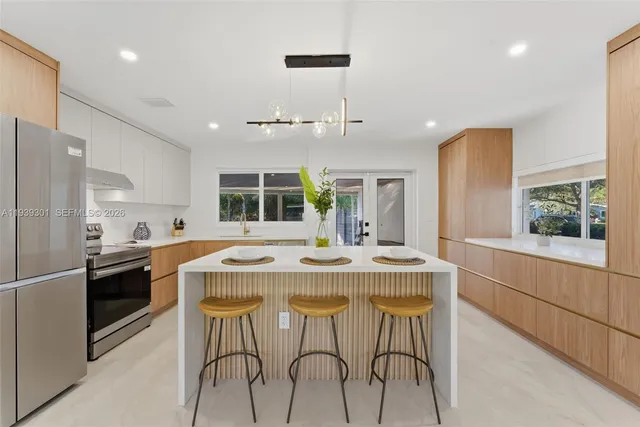 a kitchen with stainless steel appliances granite countertop a stove and refrigerator
