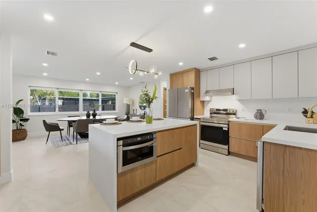 a large kitchen with kitchen island a sink a stove a center island and a center island