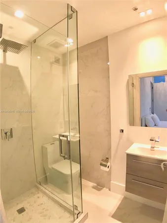 a bathroom with a shower and a sink