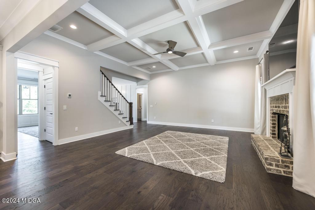 411 Crescent Drive Forsyth, GA 31029 - Photo 16 of 57 a view of an empty room with wooden floor and a ceiling fan