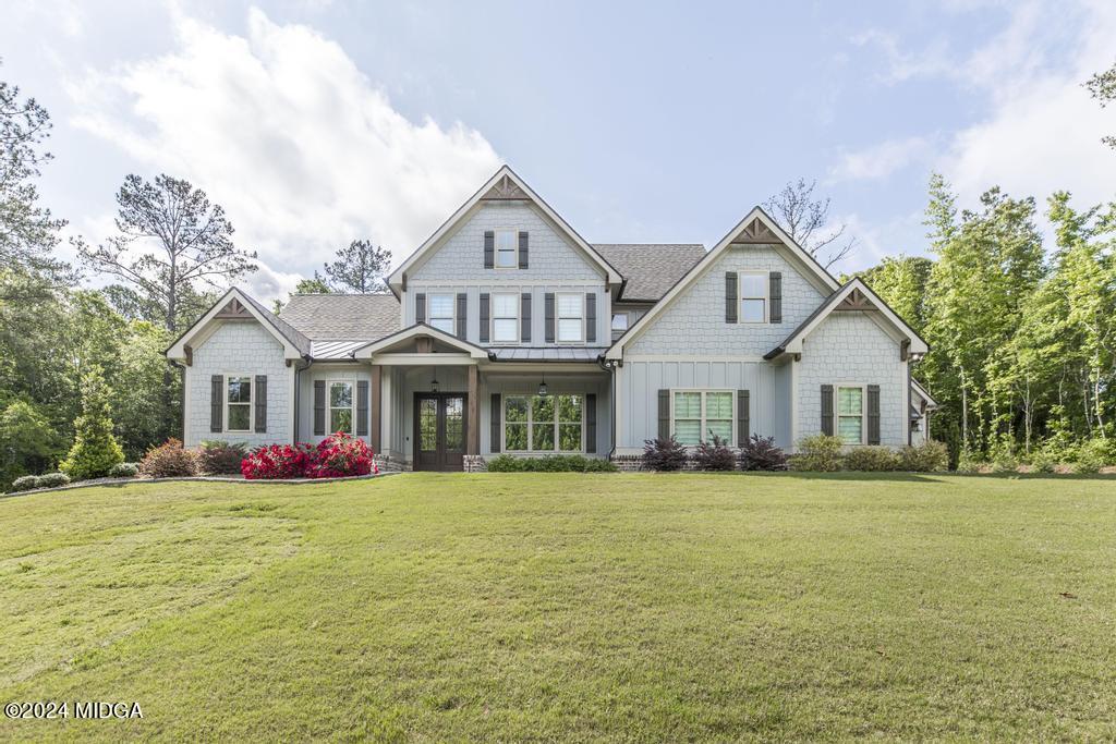 411 Crescent Drive Forsyth, GA 31029 - Photo 2 of 57 a front view of house with yard and green space