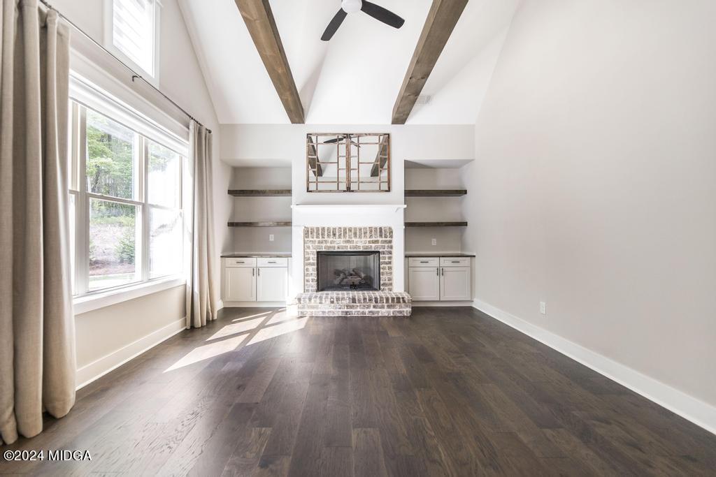 411 Crescent Drive Forsyth, GA 31029 - Photo 25 of 57 an empty room with wooden floor fire place and windows