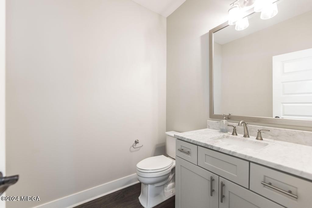 411 Crescent Drive Forsyth, GA 31029 - Photo 26 of 57 a bathroom with a toilet a sink and mirror