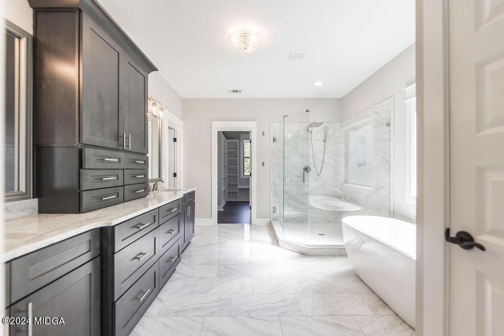 411 Crescent Drive Forsyth, GA 31029 - Photo 29 of 57 a large bathroom with a glass door shower a sink and a mirror