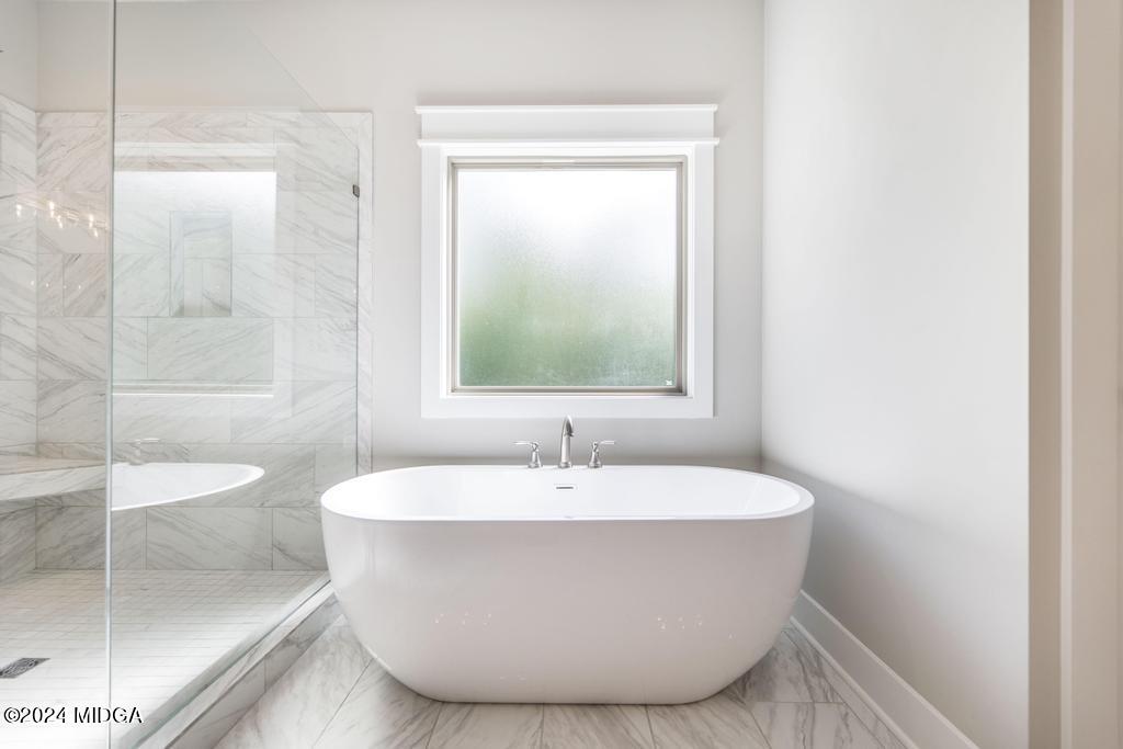 411 Crescent Drive Forsyth, GA 31029 - Photo 31 of 57 a white bath tub sitting next to a white sink