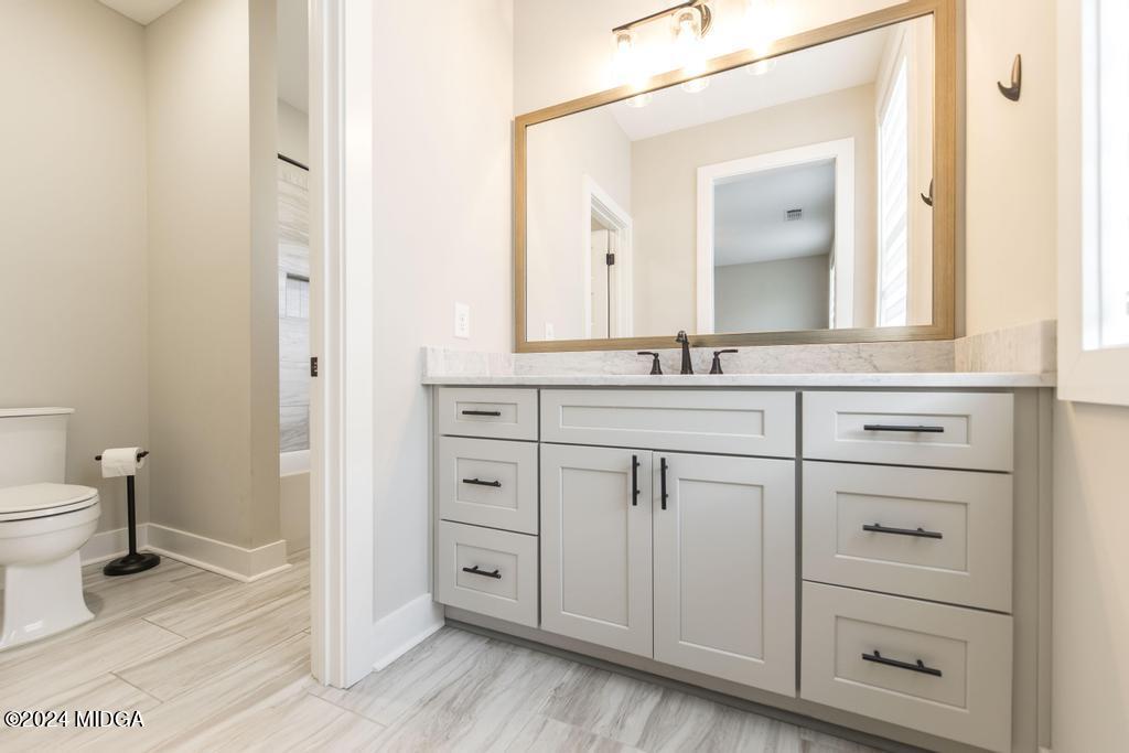 411 Crescent Drive Forsyth, GA 31029 - Photo 38 of 57 a bathroom with a sink a toilet and a mirror