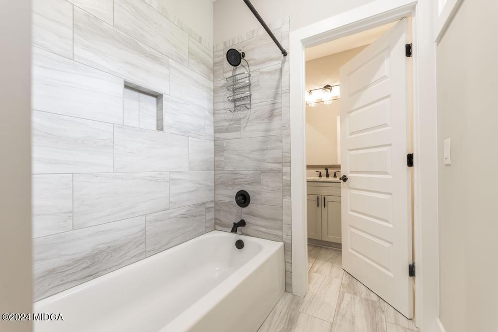 411 Crescent Drive Forsyth, GA 31029 - Photo 39 of 57 a bathroom with a bathtub and a shower