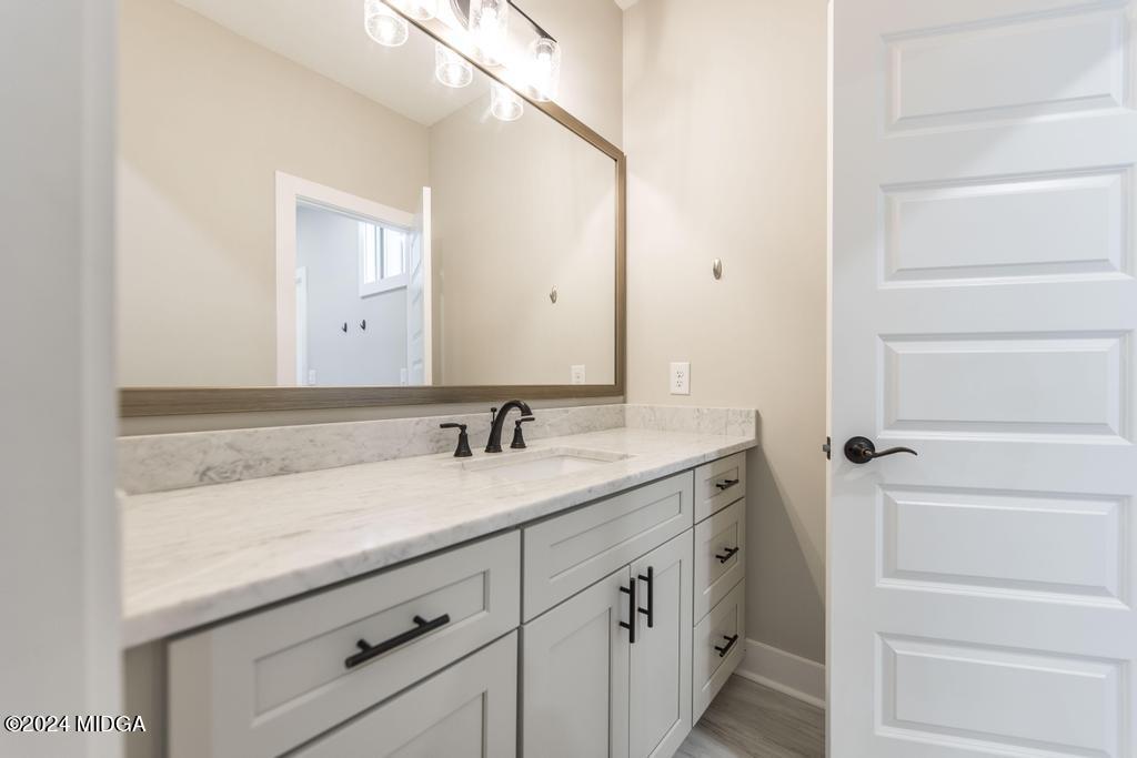 411 Crescent Drive Forsyth, GA 31029 - Photo 40 of 57 a bathroom with a sink and a mirror