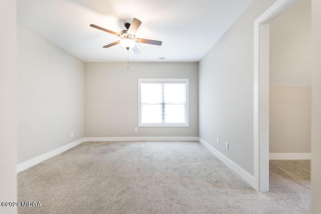 411 Crescent Drive Forsyth, GA 31029 - Photo 41 of 57 an empty room with closet and ceiling fan