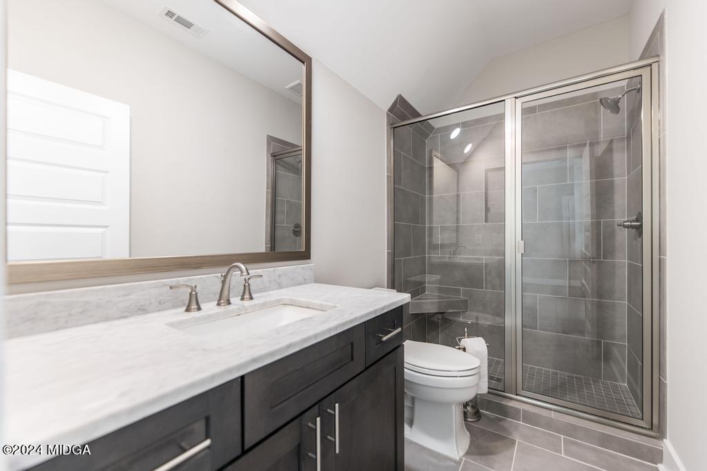 411 Crescent Drive Forsyth, GA 31029 - Photo 46 of 57 a bathroom with a sink a toilet and shower