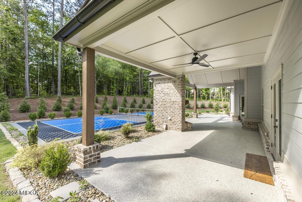 411 Crescent Drive Forsyth, GA 31029 - Photo 49 of 57 a view of a patio with a table chairs and a backyard