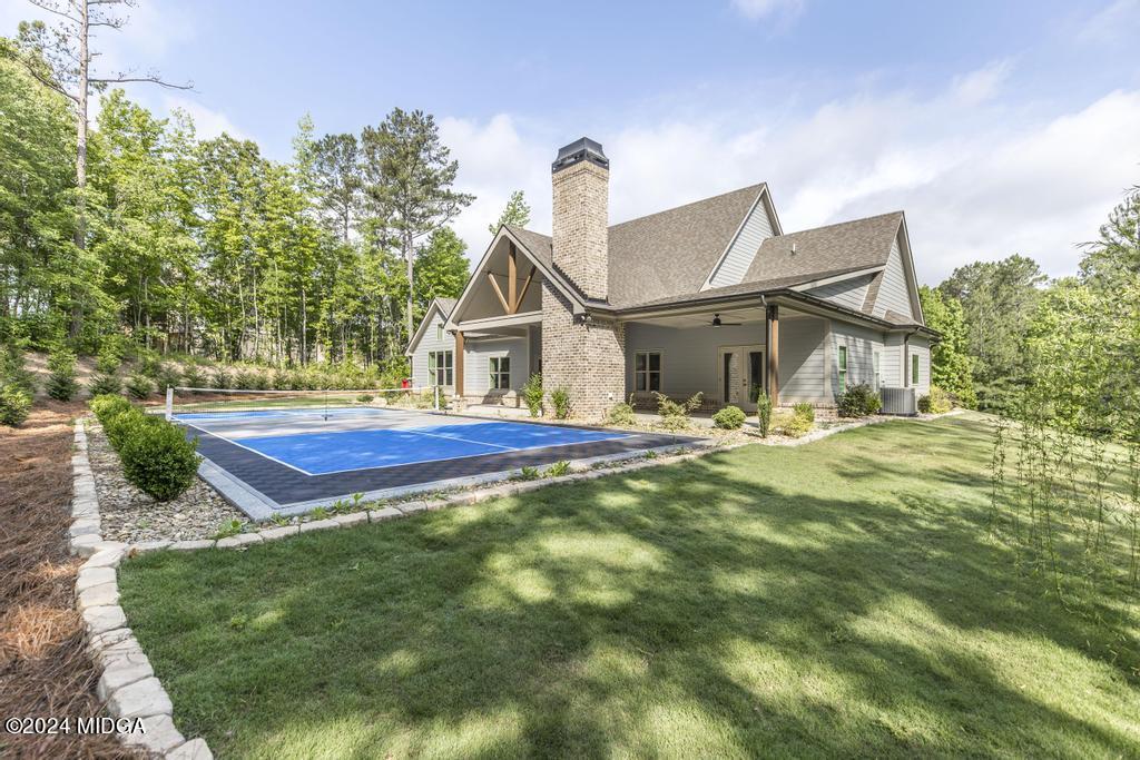 411 Crescent Drive Forsyth, GA 31029 - Photo 51 of 57 a front view of a house with garden