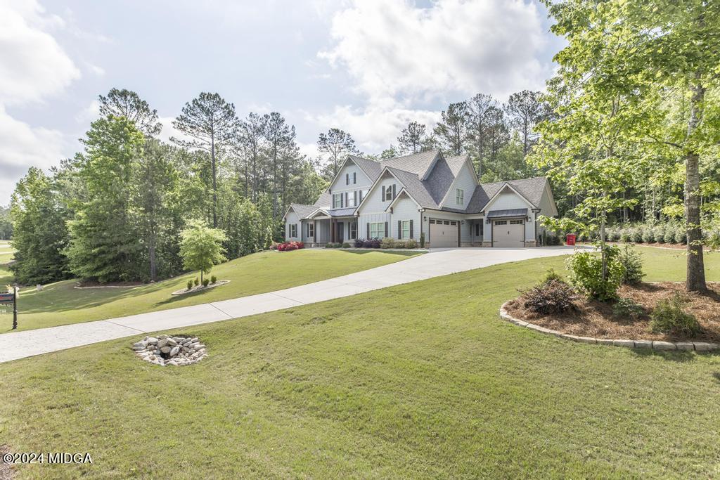 411 Crescent Drive Forsyth, GA 31029 - Photo 6 of 57 a view of a house with swimming pool and a yard