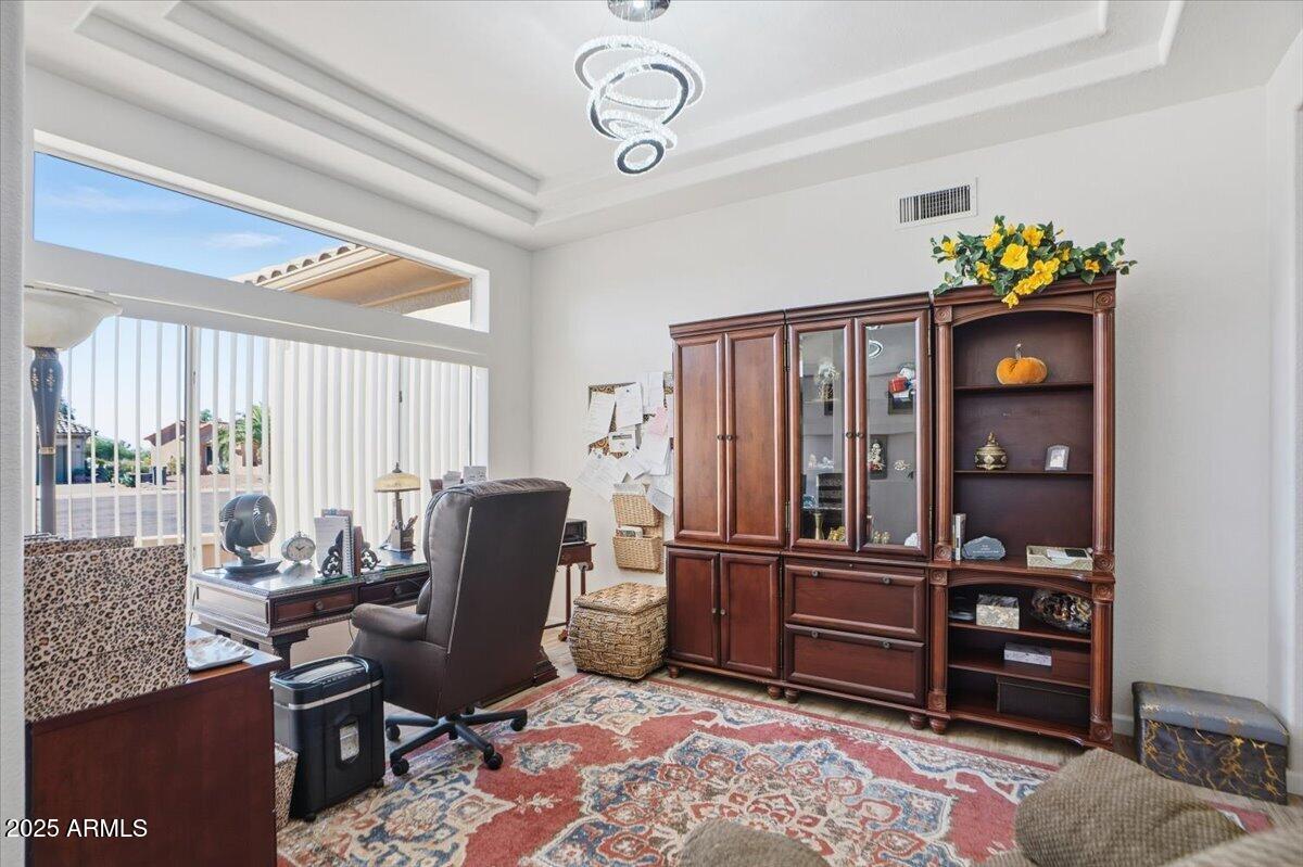 22318 North Dusty Trail Boulevard Sun City West, AZ 85375 - Photo 13 of 66 a view of a workspace with furniture and a window