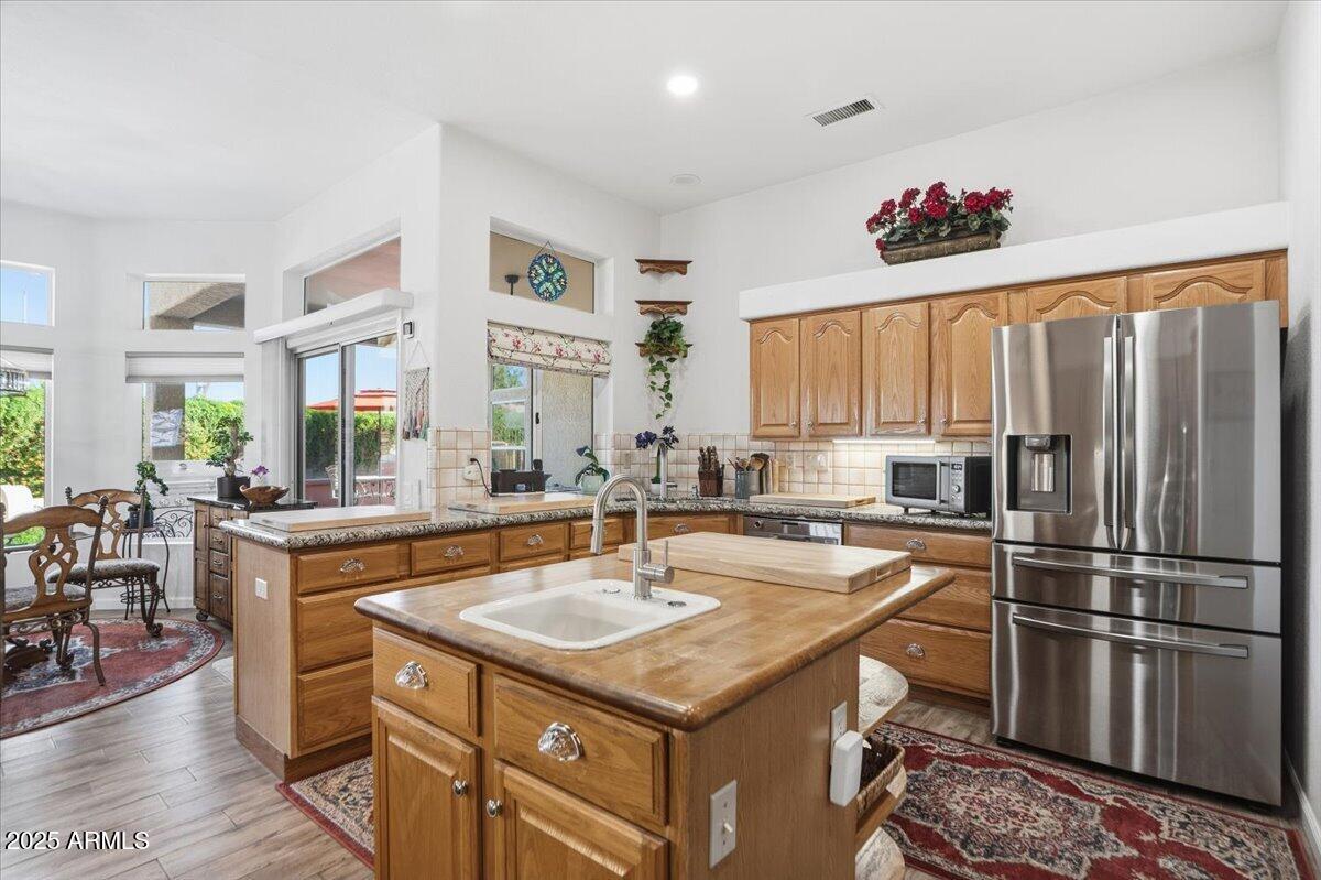 22318 North Dusty Trail Boulevard Sun City West, AZ 85375 - Photo 15 of 66 a kitchen with stainless steel appliances granite countertop a sink stove and refrigerator