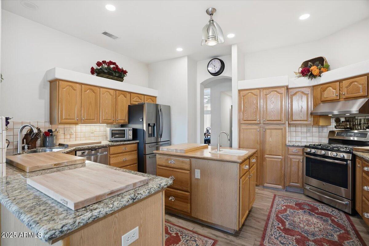 22318 North Dusty Trail Boulevard Sun City West, AZ 85375 - Photo 16 of 66 a kitchen with a sink stove and refrigerator
