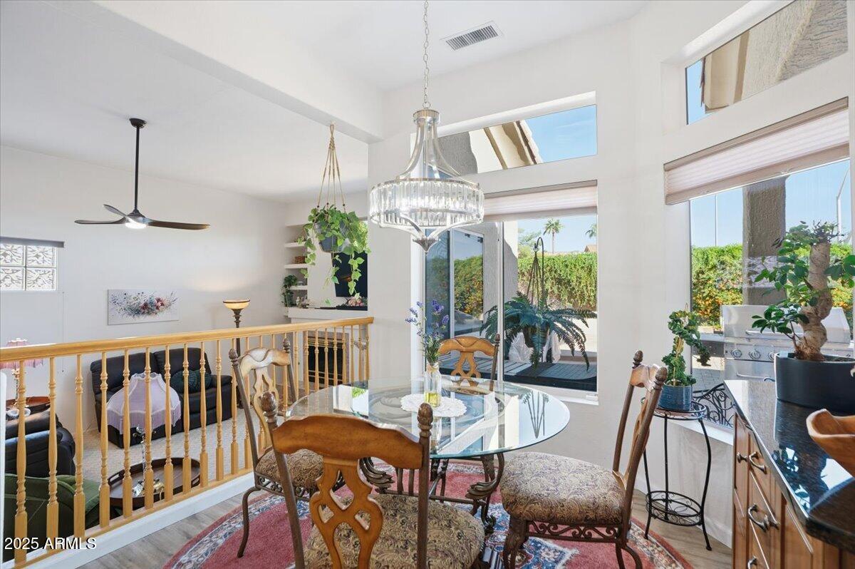 22318 North Dusty Trail Boulevard Sun City West, AZ 85375 - Photo 19 of 66 a view of a dining room with furniture window and wooden floor