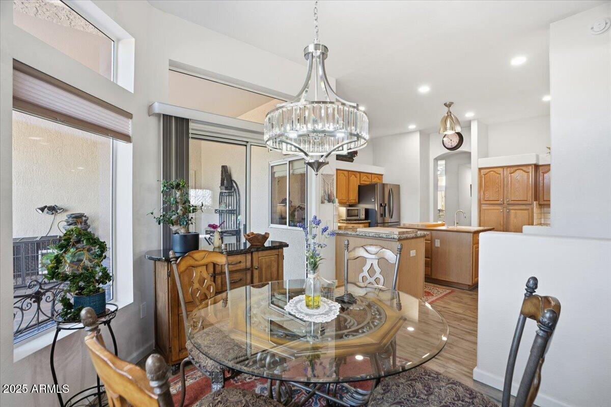 22318 North Dusty Trail Boulevard Sun City West, AZ 85375 - Photo 20 of 66 a view of a dining room with furniture and wooden floor