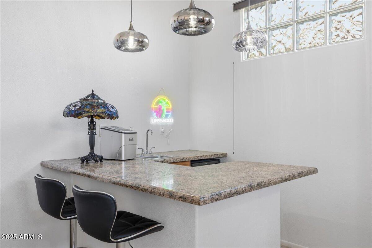 22318 North Dusty Trail Boulevard Sun City West, AZ 85375 - Photo 22 of 66 a kitchen with a counter space a sink and chandelier