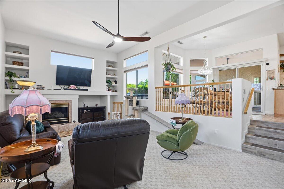 22318 North Dusty Trail Boulevard Sun City West, AZ 85375 - Photo 24 of 66 a living room with furniture a flat screen tv and a fireplace