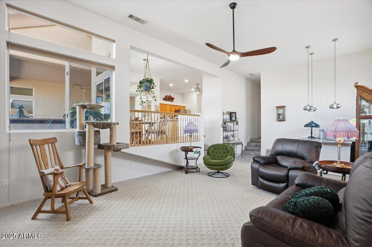 22318 North Dusty Trail Boulevard Sun City West, AZ 85375 - Photo 25 of 66 a living room with furniture a dining table and chairs