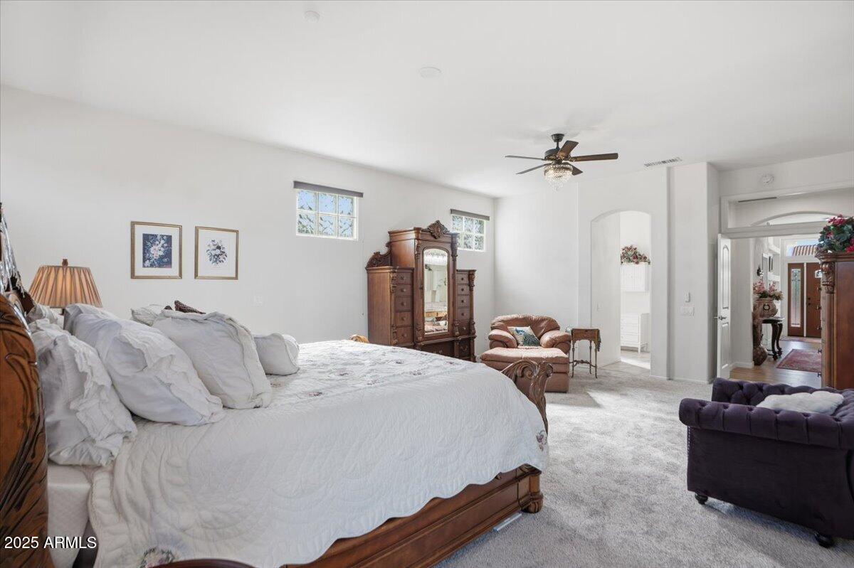 22318 North Dusty Trail Boulevard Sun City West, AZ 85375 - Photo 27 of 66 a bedroom with a bed and ceiling fan