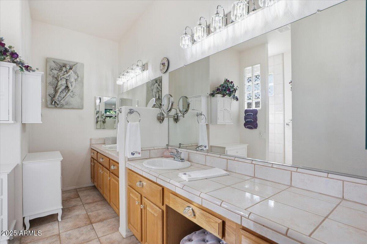 22318 North Dusty Trail Boulevard Sun City West, AZ 85375 - Photo 28 of 66 a spacious bathroom with a granite countertop sink a mirror and shower