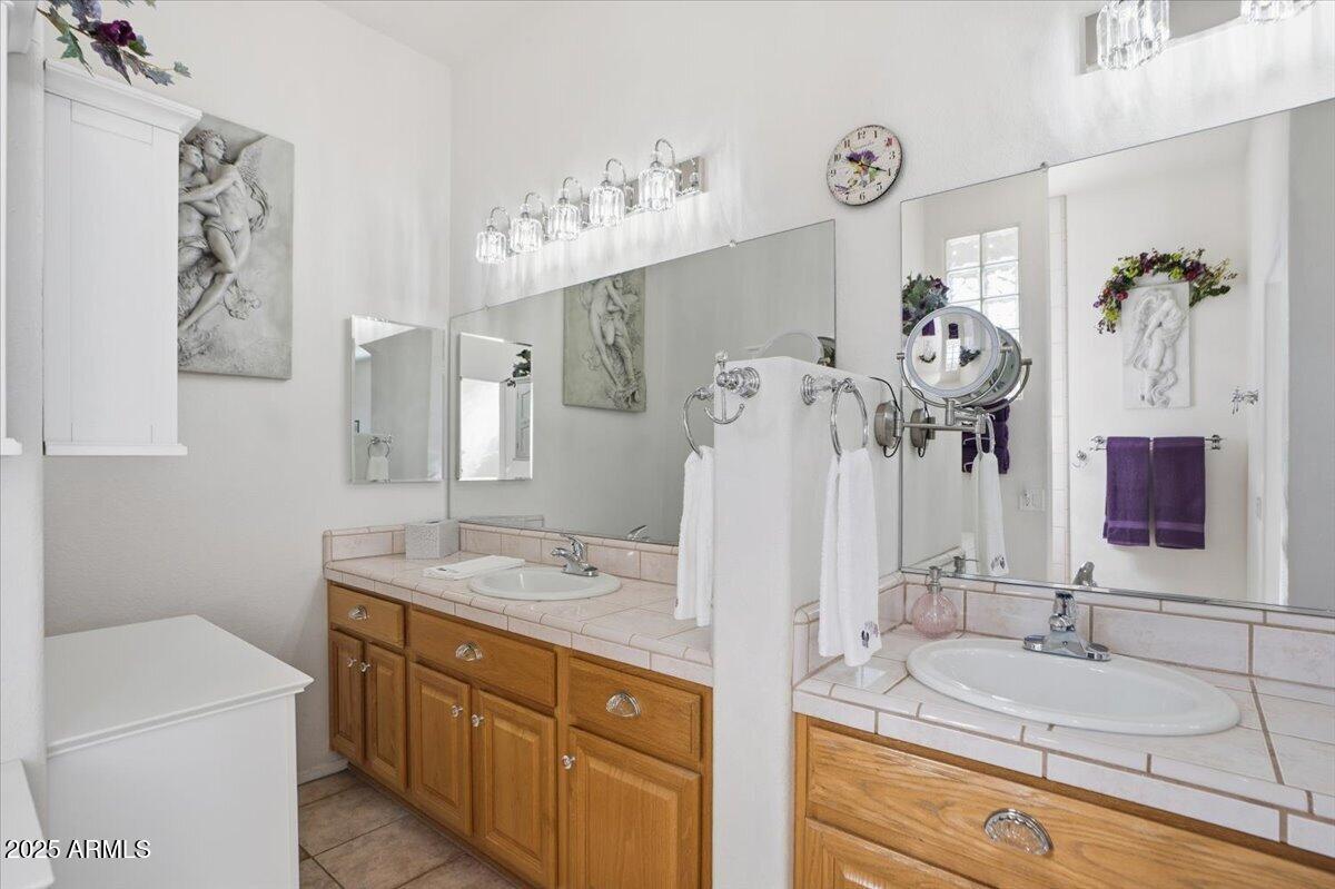22318 North Dusty Trail Boulevard Sun City West, AZ 85375 - Photo 29 of 66 a bathroom with a sink double vanity and mirror