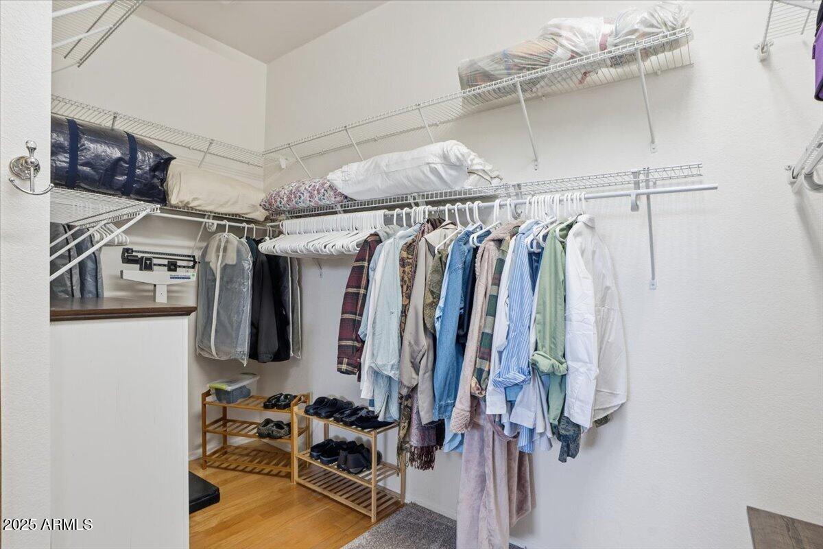 22318 North Dusty Trail Boulevard Sun City West, AZ 85375 - Photo 32 of 66 a view of walk in closet with clothes and shoes