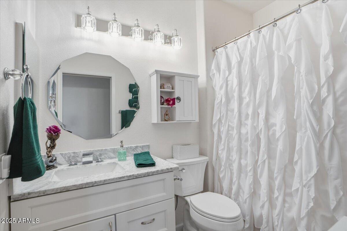 22318 North Dusty Trail Boulevard Sun City West, AZ 85375 - Photo 35 of 66 a bathroom with a sink vanity mirror and toilet