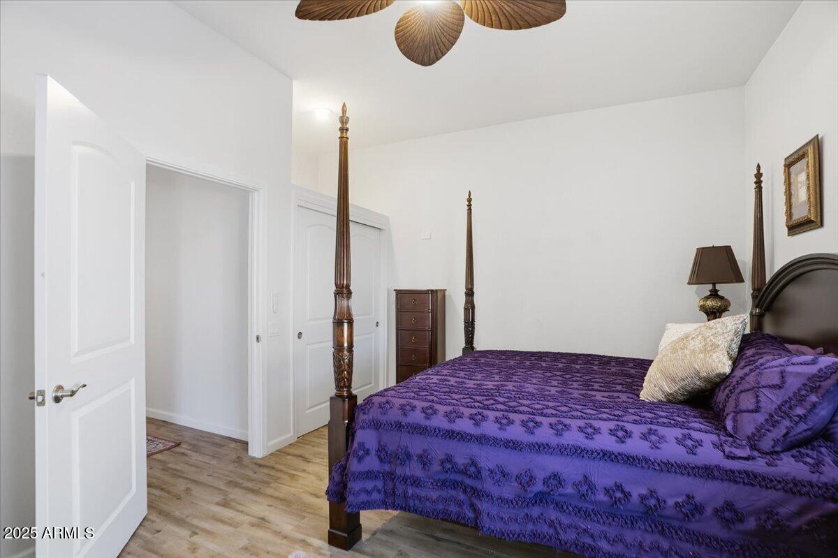 22318 North Dusty Trail Boulevard Sun City West, AZ 85375 - Photo 37 of 66 a bedroom with a large bed and a chandelier