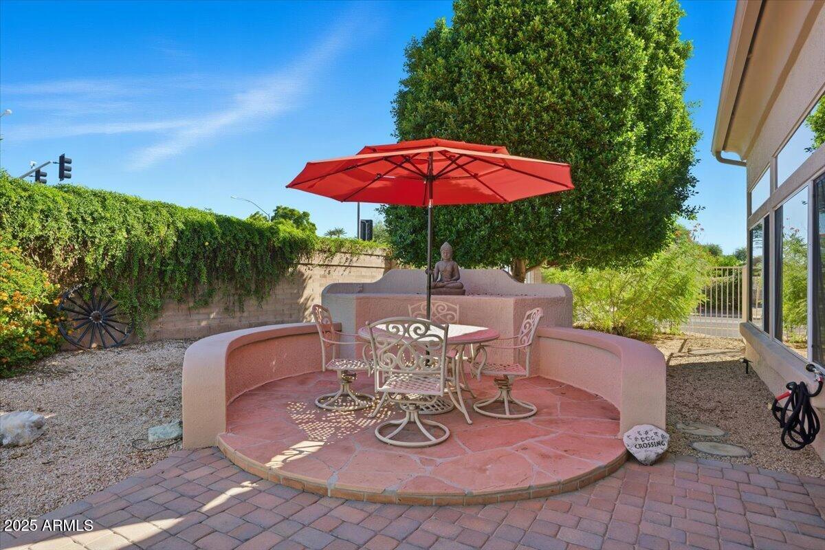 22318 North Dusty Trail Boulevard Sun City West, AZ 85375 - Photo 44 of 66 a view of a patio with a table chairs and a fire pit