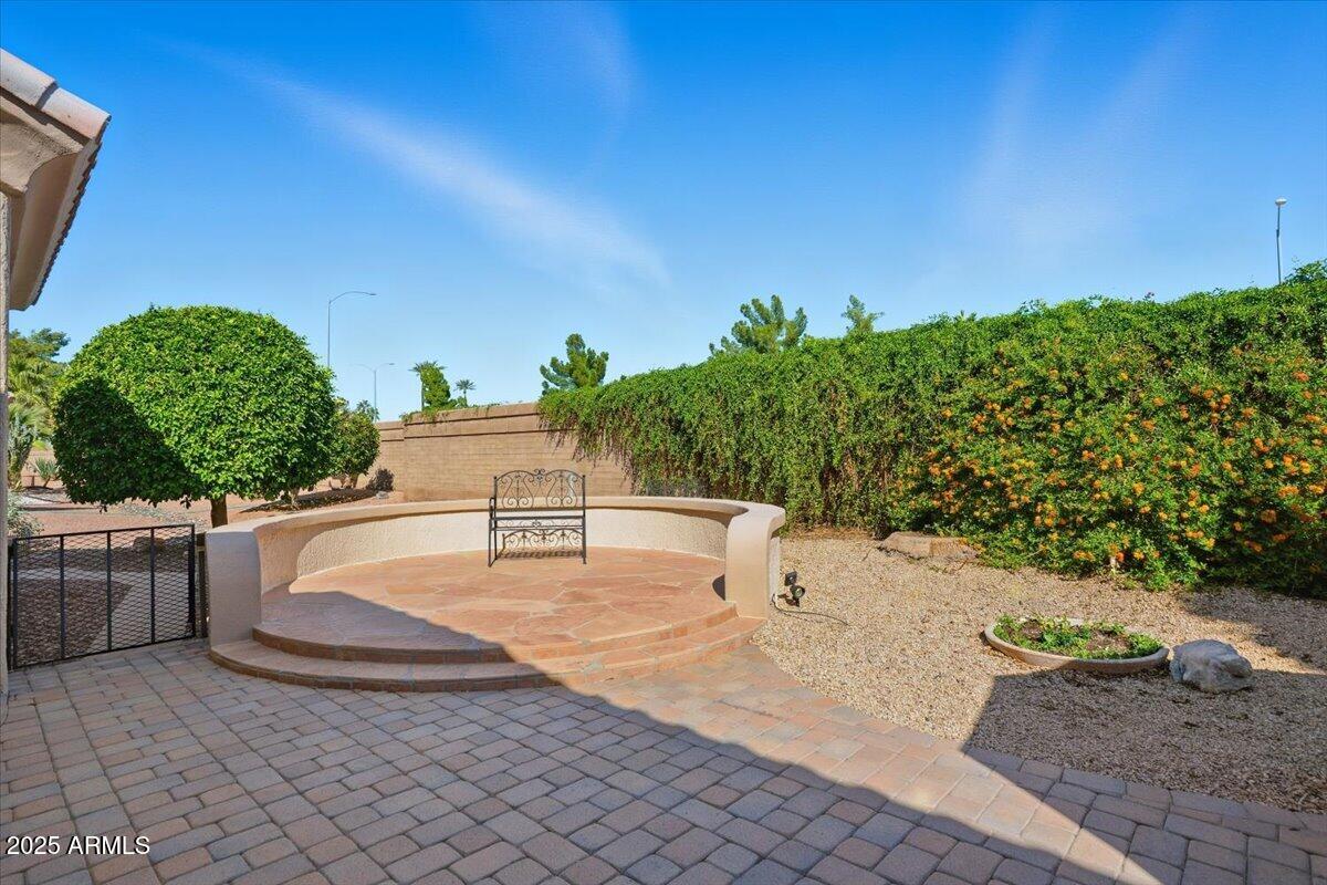 22318 North Dusty Trail Boulevard Sun City West, AZ 85375 - Photo 45 of 66 a view of a terrace with a garden