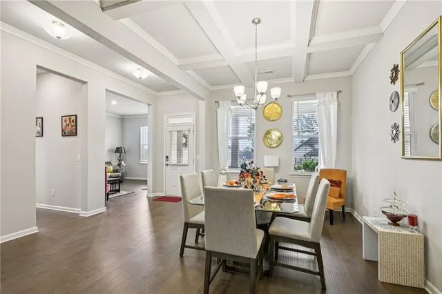 a view of a dining room with furniture and chandelier