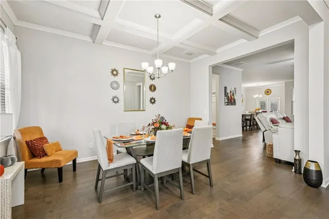 a dining room with furniture and a chandelier