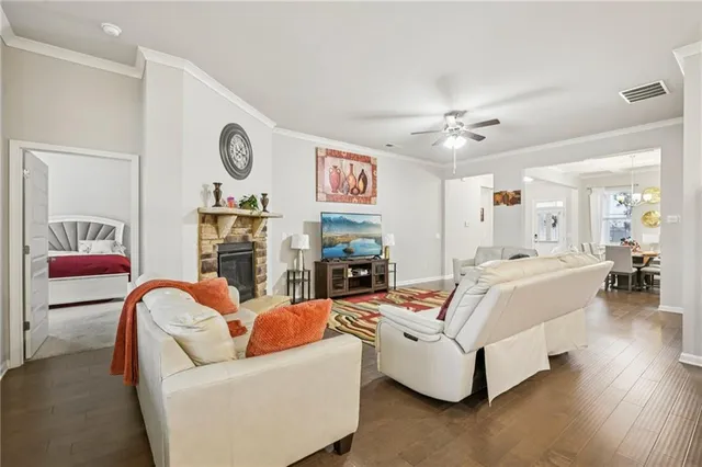 a living room with fireplace furniture and a wooden floor