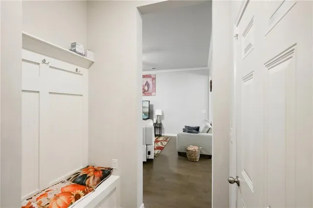 a hallway with a couch and a dining table next to a window