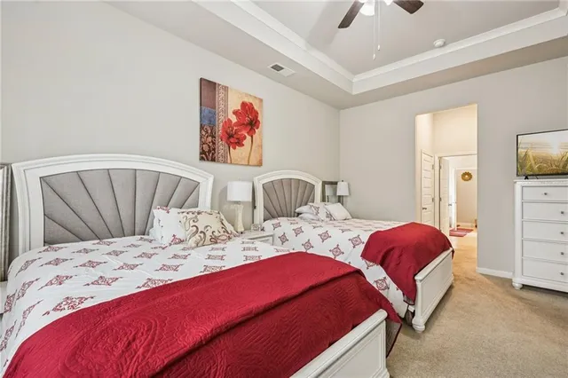 a bedroom with two beds and a dresser