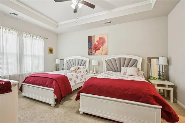 a bedroom with two beds and painted walls