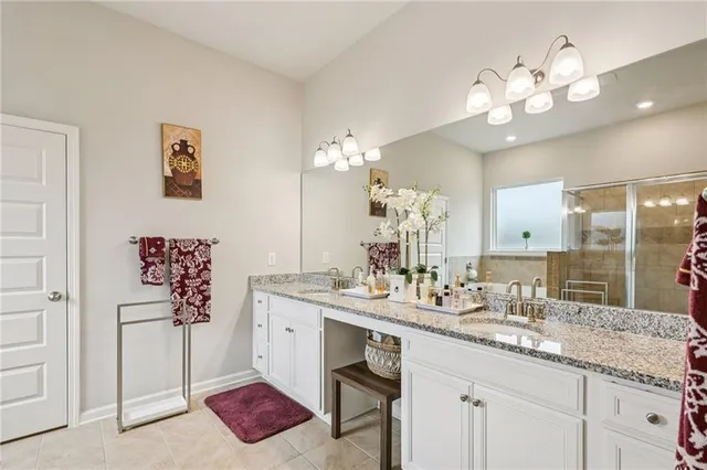 a bathroom with a sink a large mirror and a shower