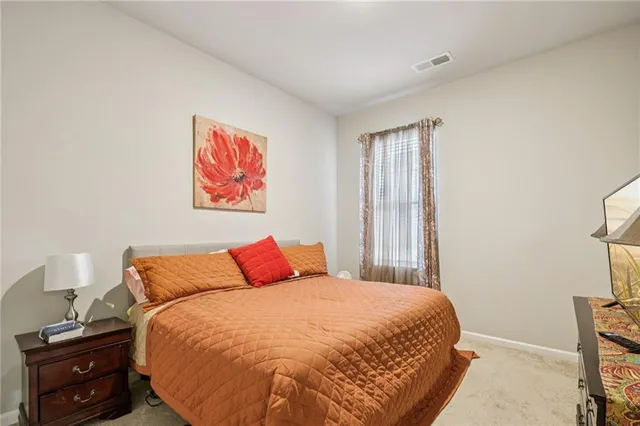 a bedroom with a bed and a night stand